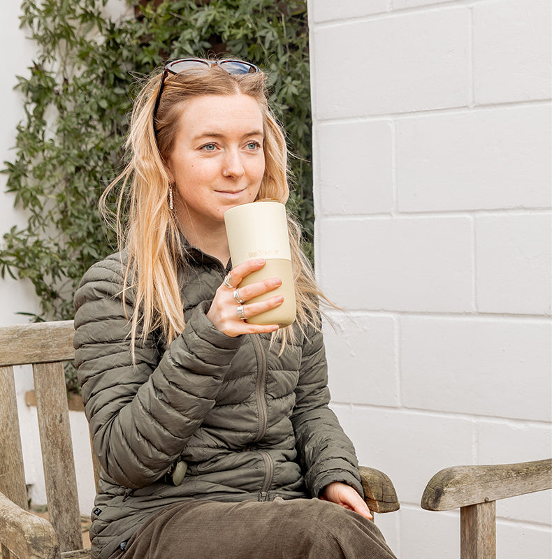 16oz-rise-tumbler-t4 16oz_rise_tumbler_wax_yellow_woman_seat_outside_square.jpg