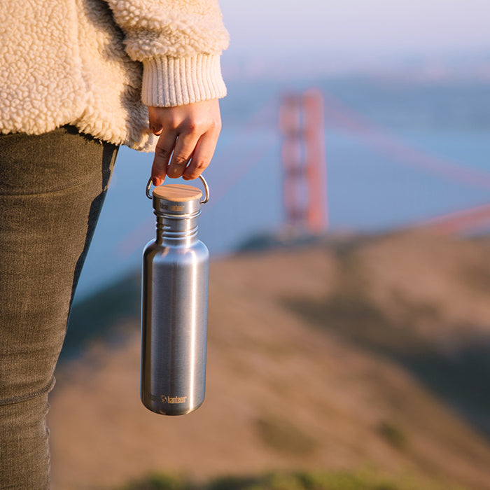 27oz-reflect-with-bamboo-cap-k7 K27SSLRF-BS-BAMBOO_reflect_bottle_bridge_lifestyle.jpg