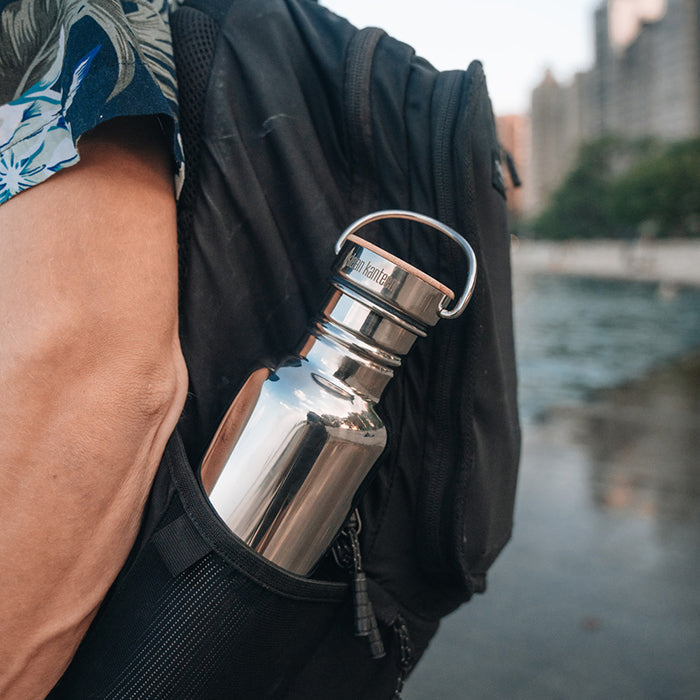 27oz-reflect-with-bamboo-cap-k7 K27SSLRF-MS-BAMBOO_reflect-bottle_backpack_lifestyle.jpg